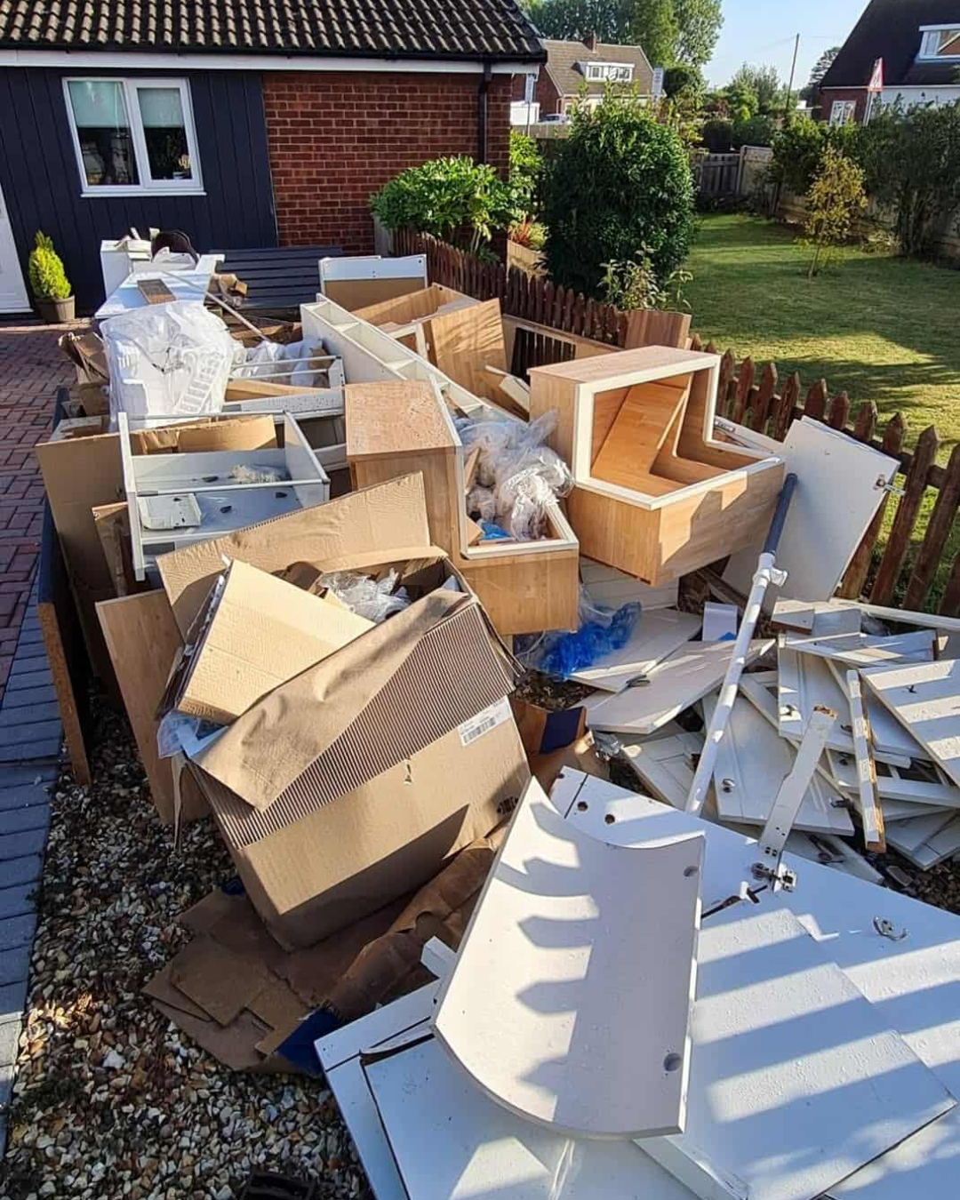 Driveway covered in boxes and furniture parts