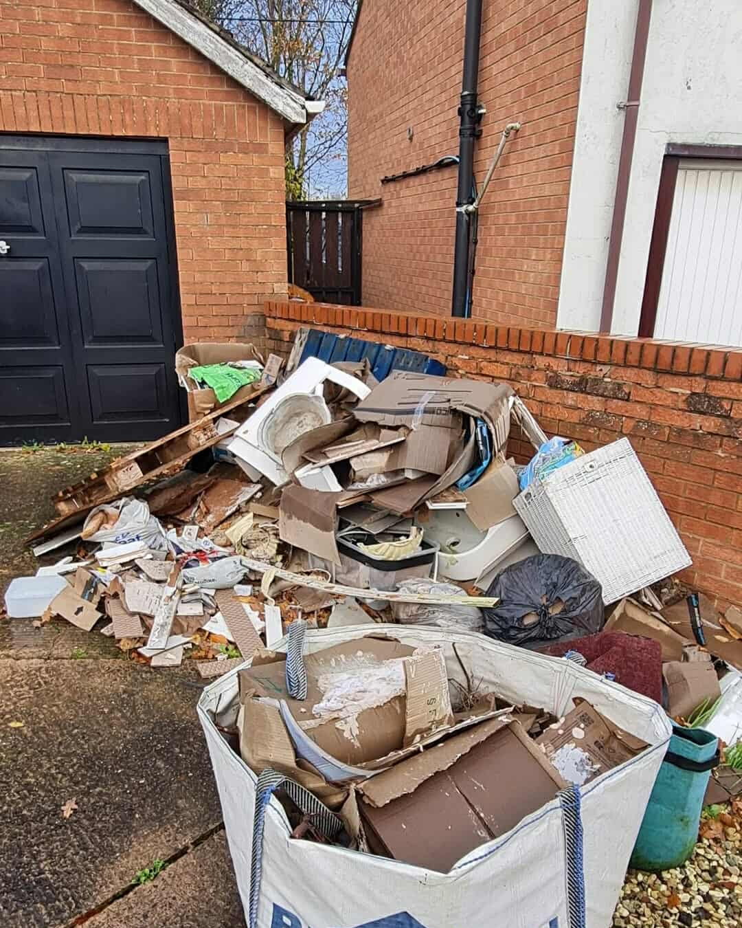 Driveway with piled boxes and rubbish